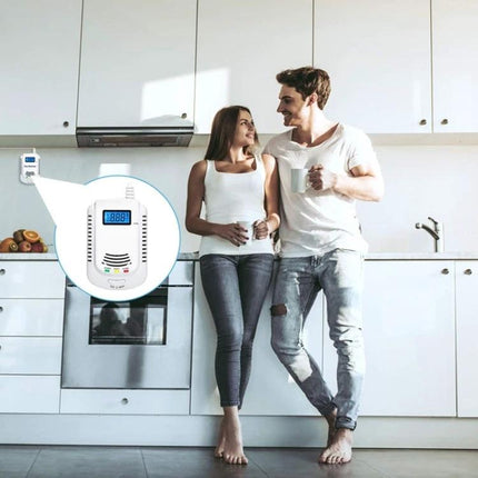 Coalgas Home Gas Leak Detector for Natural and Propane Safety mounted in modern kitchen near couple, showing digital display and alerts