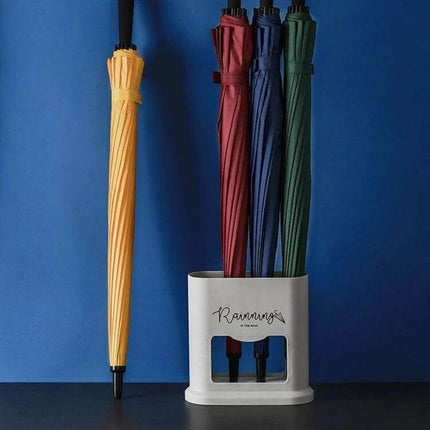 Four-Hole Umbrella Storage Rack for Home Entrance Organization holding four folded umbrellas and containing drips to keep floors dry