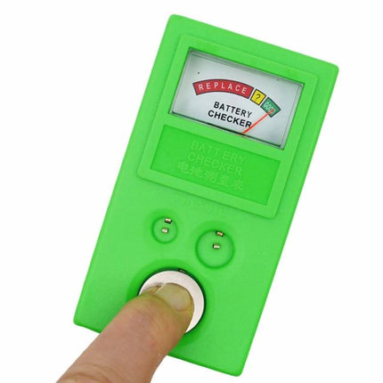 Handheld Green Watch Battery Tester for Button Cells showing finger testing a watch button cell with replace/ok meter display