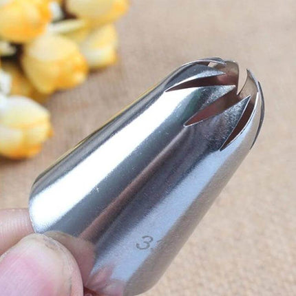 Petal Piping Nozzle Set 5 Piece Stainless Steel Cake Decorating stainless steel petal tip held close-up for piping roses and daisies