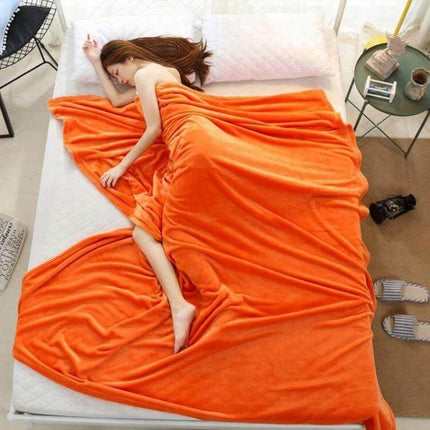Beddowell Coral Flannel Blanket 180x200cm draped over bed with person resting, bright orange 100% polyester coral fleece, lightweight and machine washable