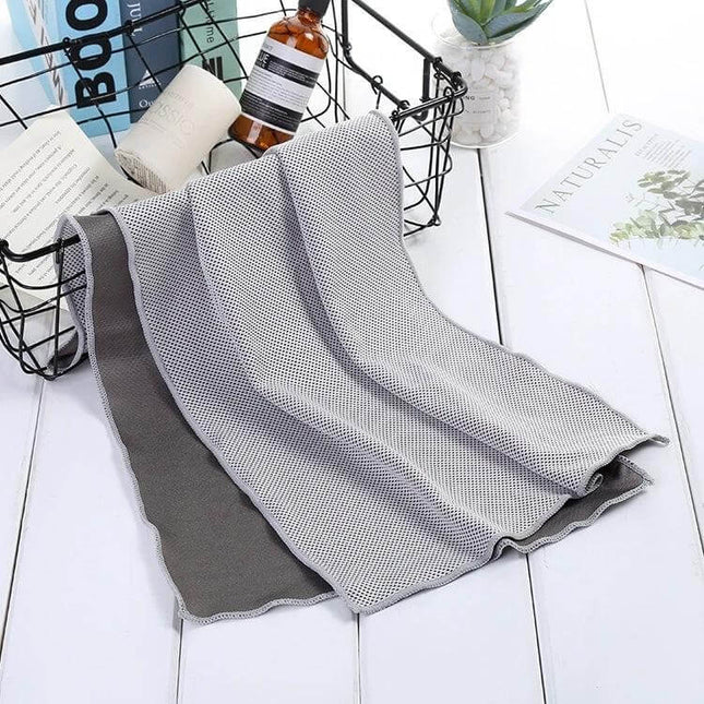 Fitness Towel Quick-Drying for Gym, Travel, and Everyday Use - Mini Grey Microfiber Cooling Towel Draped on Table