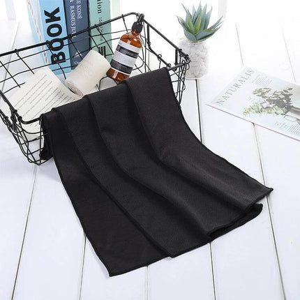 Fitness Towel Quick-Drying for Gym, Travel, and Everyday Use - Black mini microfiber cooling towel draped beside basket and travel items