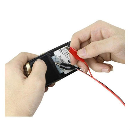 Baku DC Regulated Power Supply for Mobile Device Maintenance connected via alligator clips to a smartphone battery for repair and voltage testing