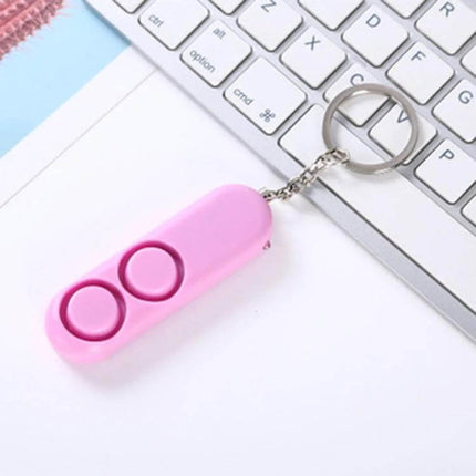 Personal Safety Alarm Keychain for Everyday Protection - pink compact keychain alarm on desk near keyboard, easy-pull pin for loud alert
