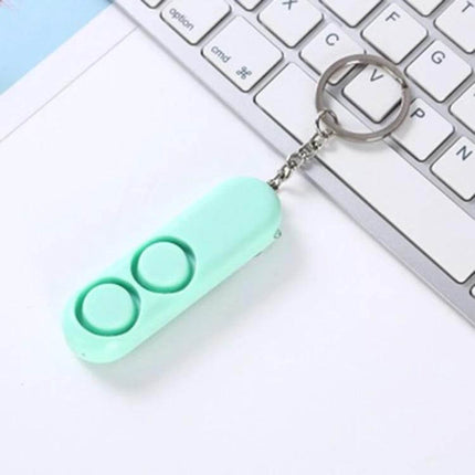 Personal Safety Alarm Keychain for Everyday Protection - mint green two-button keychain alarm shown on a keyboard
