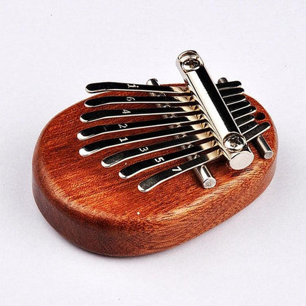 A Compact Thumb Piano for Daily Musical Expression compact mahogany kalimba 6.5x5x2.2cm pocket-sized soothing melody instrument