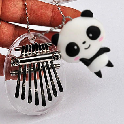 A Compact Thumb Piano for Daily Musical Expression small clear kalimba keychain with metal tines and cute panda charm
