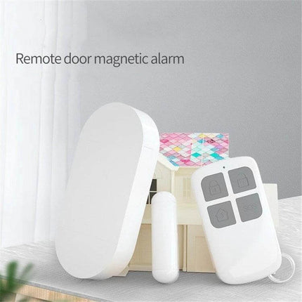 Wireless Remote Control Door and Window Security Alarm white magnetic sensor, main unit and remote shown on table