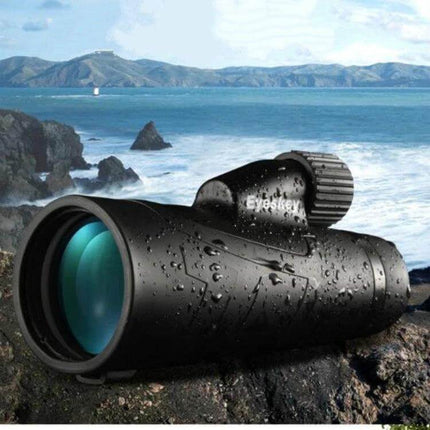 Outdoor HD Portable Monocular For Wildlife Viewing on rocky coastal overlook, waterproof black monocular with FMC lens and Bak4 prism