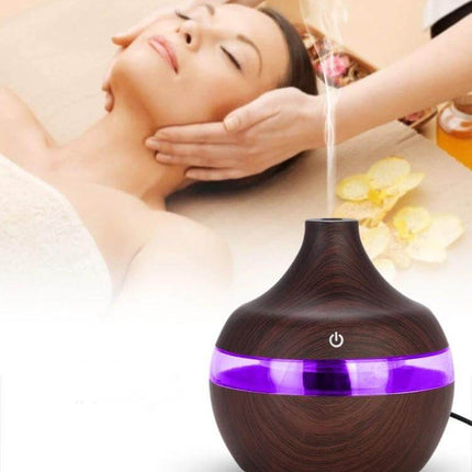Wood Grain USB Waterdrop Aromatherapy Humidifier For Desk on spa table with purple LED and wood grain finish, USB-powered 300ml desk diffuser