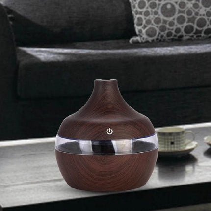 Wood Grain USB Waterdrop Aromatherapy Humidifier For Desk on coffee table with wood-grain finish and USB-powered 300ml tank