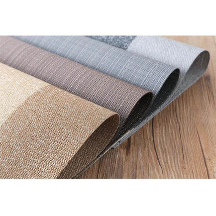 PVC Non Slip Table Mat 30x45cm Easy Clean Placemat in neutral woven colors rolled on wood surface