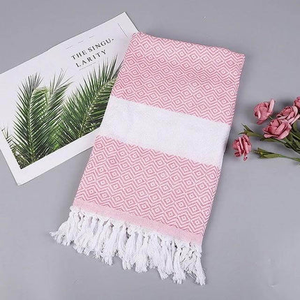 Striped Cotton Bath Towel With Tassels For Everyday Use folded pink patterned towel with white stripe and tassels