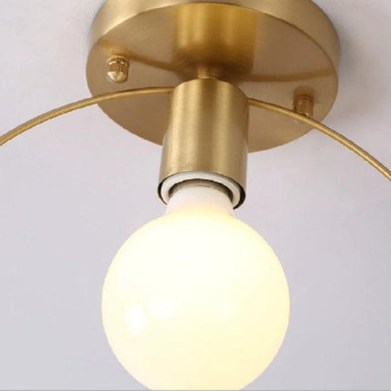 Simple Modern Copper Lamp for Everyday Home Lighting in a Nordic minimalist ceiling fixture glowing over a cozy reading nook