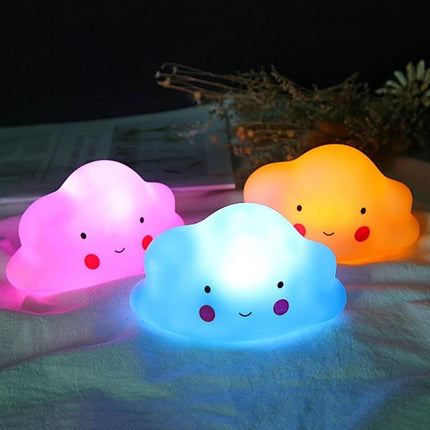 Colorful Cloud Night-Light for Kids' Bedside Routines — three smiling silicone cloud lights emitting soft pink, blue, and orange glow for bedtime