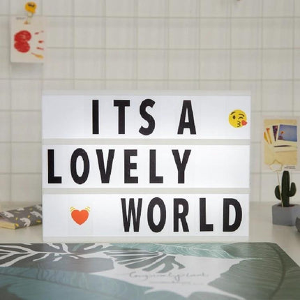 Handmade Alphabet Light Box for Home Decor and Nighttime Ambiance displaying “ITS A LOVELY WORLD” on a nightstand