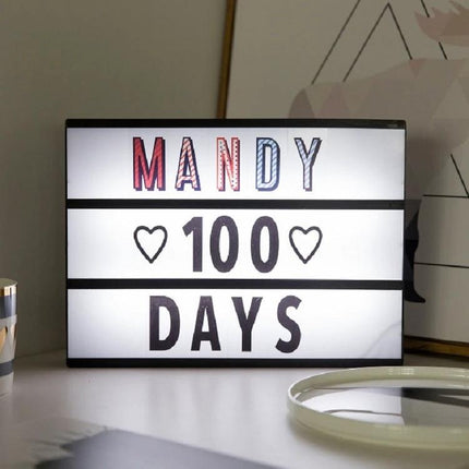 Handmade Alphabet Light Box for Home Decor and Nighttime Ambiance showing "MANDY 100 DAYS" illuminated on a nightstand