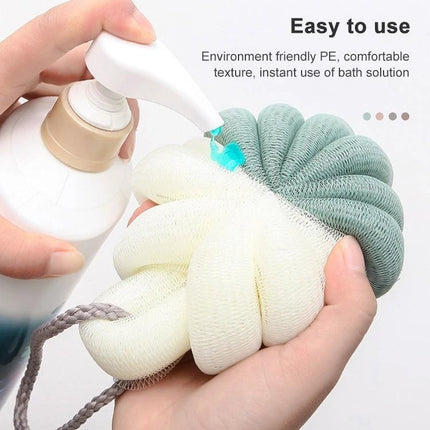 Soft Bath Brush for Daily Home and Travel Exfoliation - hands applying soap to compact travel bath brush pouf