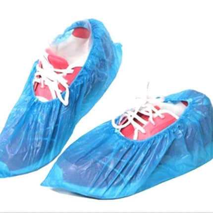 Disposable Outdoor Plastic Shoe Covers for Rain and Floor Protection, 100 Pack - Blue disposable shoe covers on sneakers for wet weather and clean floors