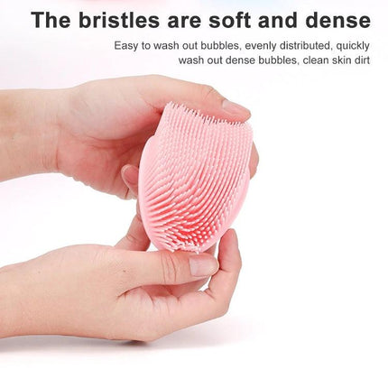 Soft Silicone Brush For Gentle Massage During Baby Bath Time - pink flexible silicone bristle brush shown in hands for gentle baby bath cleaning