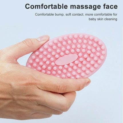Soft Silicone Brush For Gentle Massage During Baby Bath Time - pink soft silicone massage brush with rounded nubs held in hand