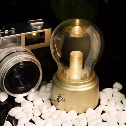 Vintage Night Light for Home Bedside and Kitchen Use glowing warm yellow bulb on bedside table next to camera, compact vintage design