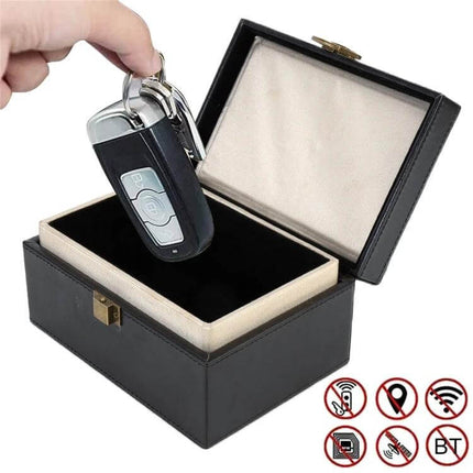 PU Leather Anti-Theft Shield Box for Phone and Keys, Black holding car key fob inside RFID-shielded lined interior, compact protective storage box