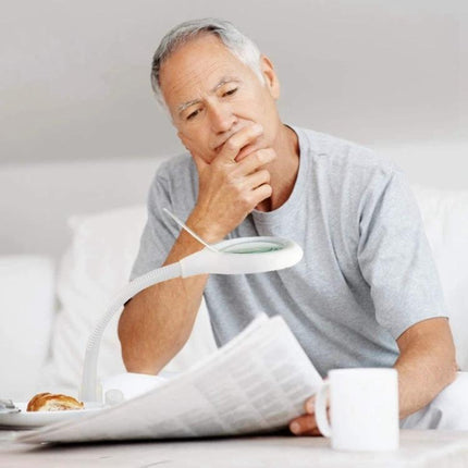Versatile Magnifying Desk Lamp for Daily Reading and Crafts showing an elderly man using magnifier to read newspaper