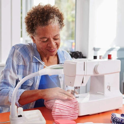 Versatile Magnifying Desk Lamp for Daily Reading and Crafts aiding a woman sewing with 360-degree adjustable arm to reduce eye strain