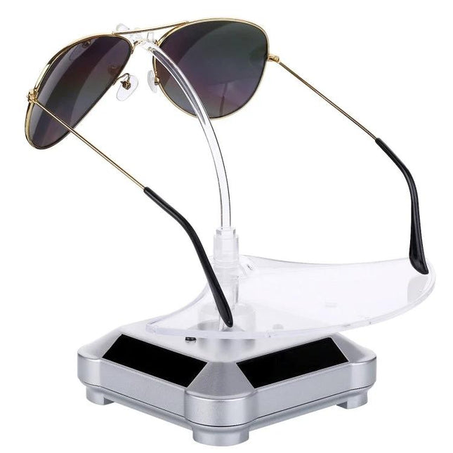 Solar-Powered Rotating Display Stand for Glasses with Lights showing aviator sunglasses on a clear rotating holder with colorful LED accents