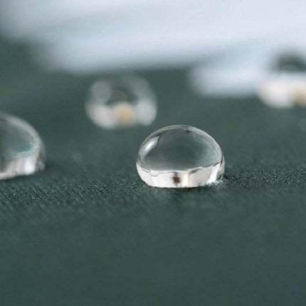 GD Daisy Folding Umbrella for Sun and Rain Protection water-repellent fabric close-up with raindrops on dark green canopy
