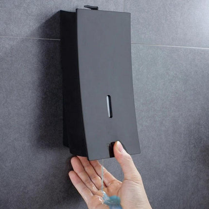 Wall-Mounted Dispenser for Everyday Bathroom Essentials in matte black mounted on tile dispensing blue soap into hand