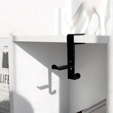 Under Desk Metal Headphone Hook For Desk Organization And Storage mounted on white desk edge holding headphones