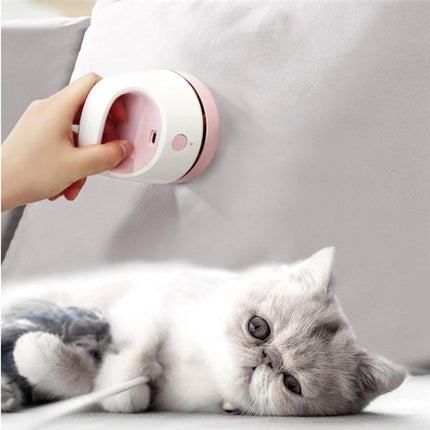 Compact USB Charging Vacuum for Desktop and Keyboard Cleaning used to remove pet hair and dust from a sofa and nearby keyboard area