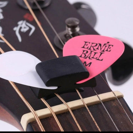 Alice Guitar Pick Clip for Everyday Music Practice Sessions black rubber pick clip holding two picks on acoustic guitar headstock