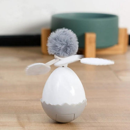 Engaging Tumbler Toy for Cats During Home Playtime - self-running egg-shaped toy with pom pom and paddles for indoor cat exercise