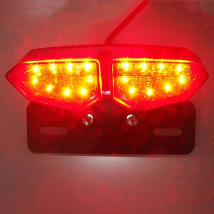 Motorcycle LED Tail Light with Integrated Brake and Turn Signals mounted on bracket glowing red for brake and amber turn signal visibility