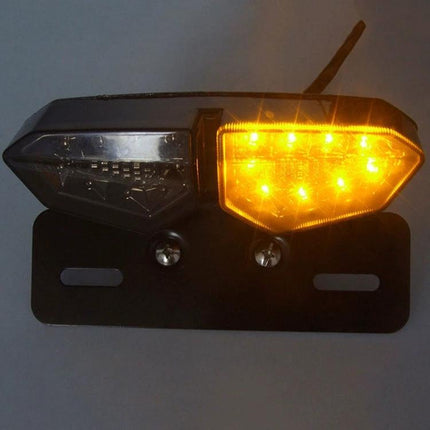 Motorcycle LED Tail Light with Integrated Brake and Turn Signals mounted on black bracket showing amber turn LEDs illuminated