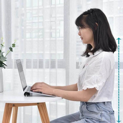 Compact Laptop Stand with Built-in Cooling Fan for Laptops shown supporting a laptop at desk for ergonomic cooling