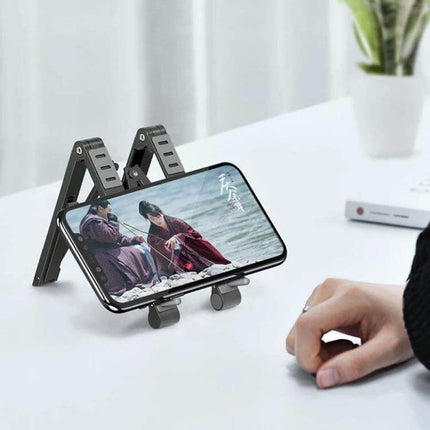Folding Aluminum Laptop Stand for Elevated Device Use holding a smartphone at eye level on a desk, lightweight foldable aluminum stand