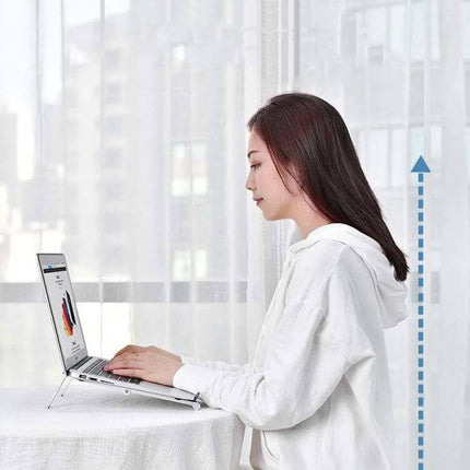 Folding Aluminum Laptop Stand for Elevated Device Use helping woman maintain ergonomic eye level with laptop and tidy workspace