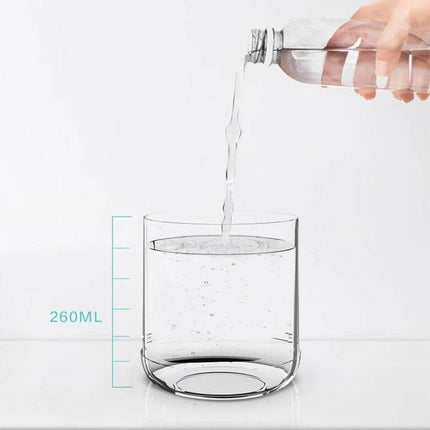 Car Portable Humidifier Pearl White With Night Light showing 260ml water fill demonstration in clear measuring glass