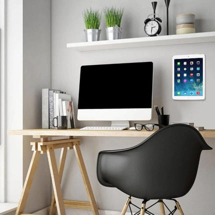 Universal Wall-Mounted Magnetic Holder for iPads and Phones mounted beside a modern desk and monitor for hands-free viewing