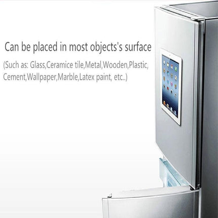 Universal Wall-Mounted Magnetic Holder for iPads and Phones mounted on refrigerator holding an iPad for hands-free kitchen use