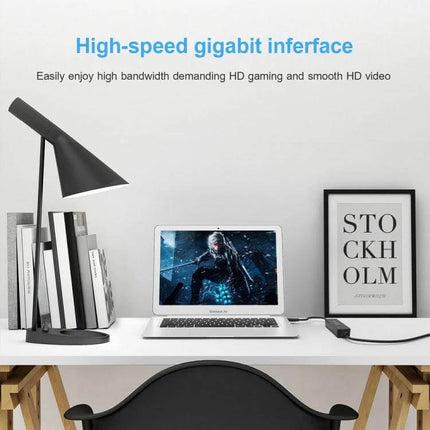 USB Ethernet Adapter for Laptop Wired Network Connections plugged into laptop on a tidy desk setup for stable wired internet