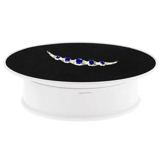 30cm Electric Rotating Turntable for Photography Displays with black velvet top and white ABS base showcasing jewelry