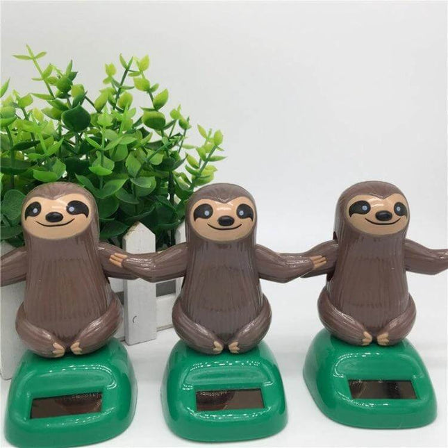 Solar Powered Dancing Sloth Toy for Car Dashboard Decoration - trio of solar-powered dancing sloth dashboard toys on green bases