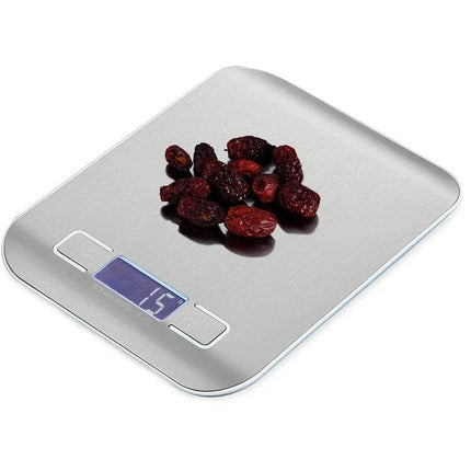 Rose Gold Digital Kitchen Scale For Precise Ingredient Weighing — stainless steel surface with backlit LCD showing 15g and dried fruit on scale