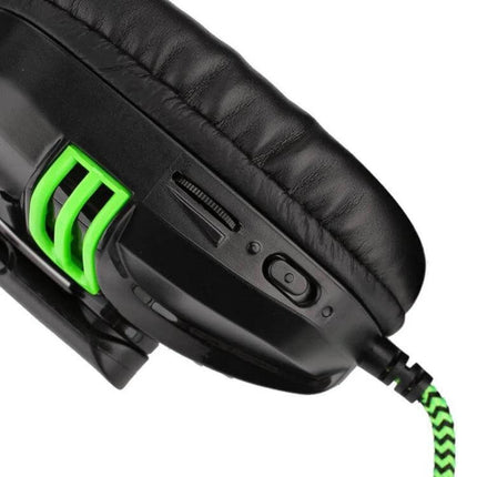 Salar Wired Stereo Headset With Microphone For Calls And Music close-up of black earcup, green accents, 3.5mm cable and in-line controls